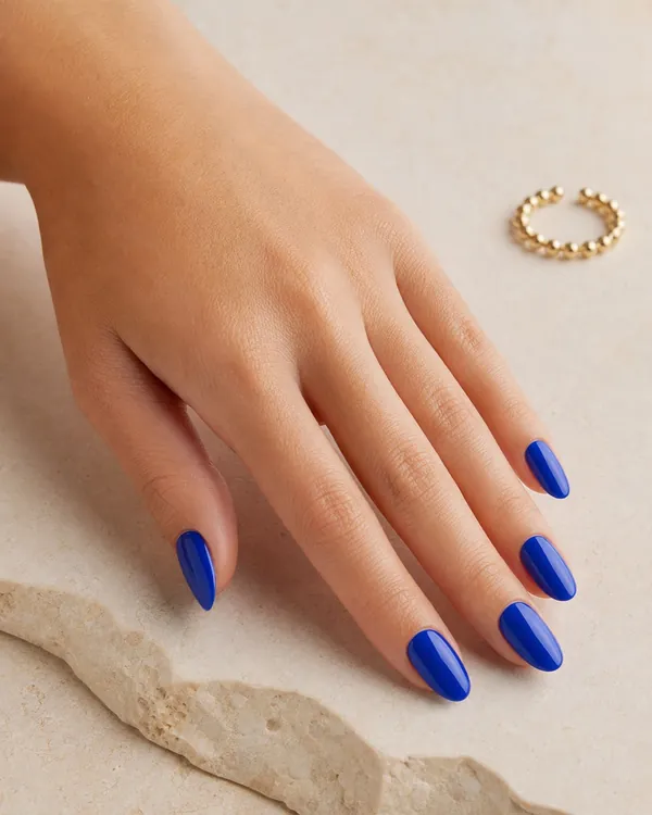 Medium almond nails in a glossy cobalt blue
