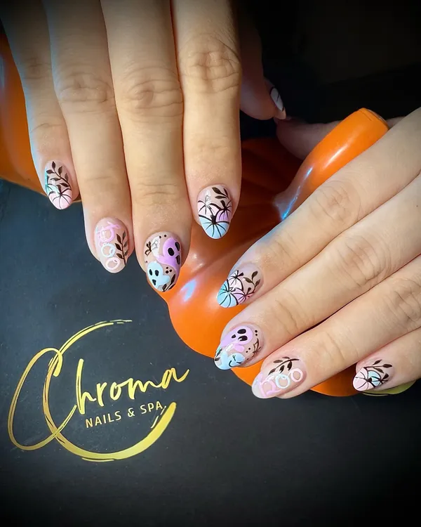 Soft pastel nails with dark botanical line art