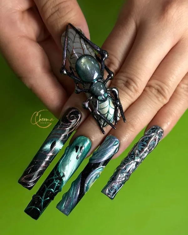Extra-long emerald and silver nails with spider web line art and a 3D spider charm