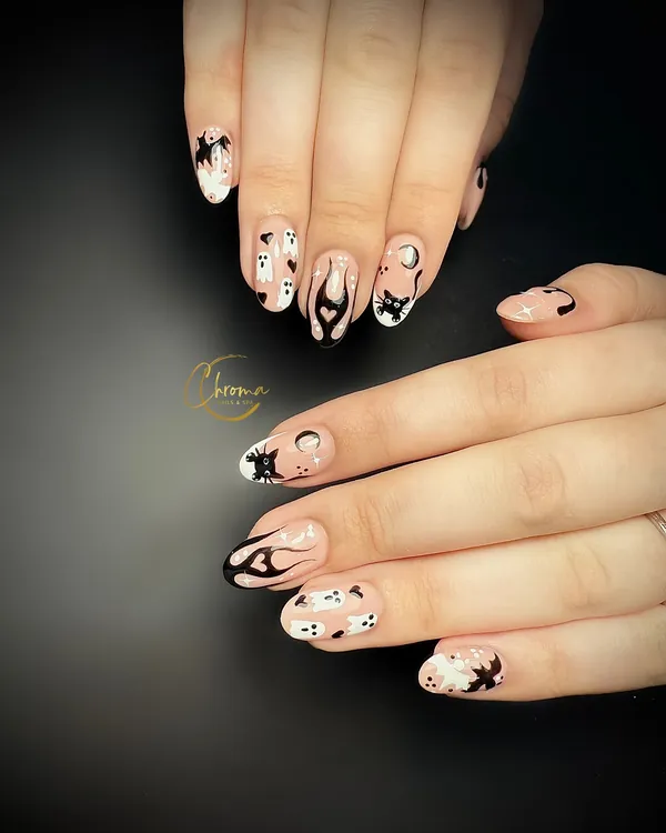 Nude almond nails hand-painted with tiny ghosts, bats, black cats and flames
